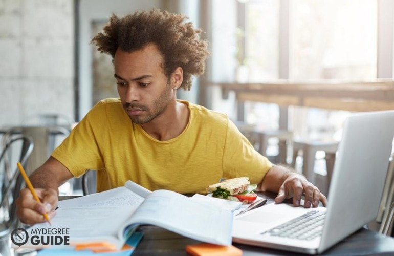 Engineering Degree student studying online at a cafe