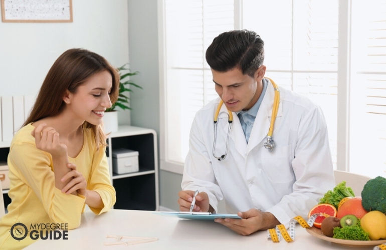 Nutritionist providing feedback to his client