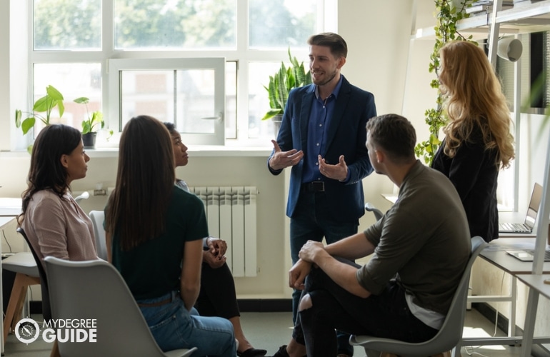 Training & Development Manager discussing to some employees