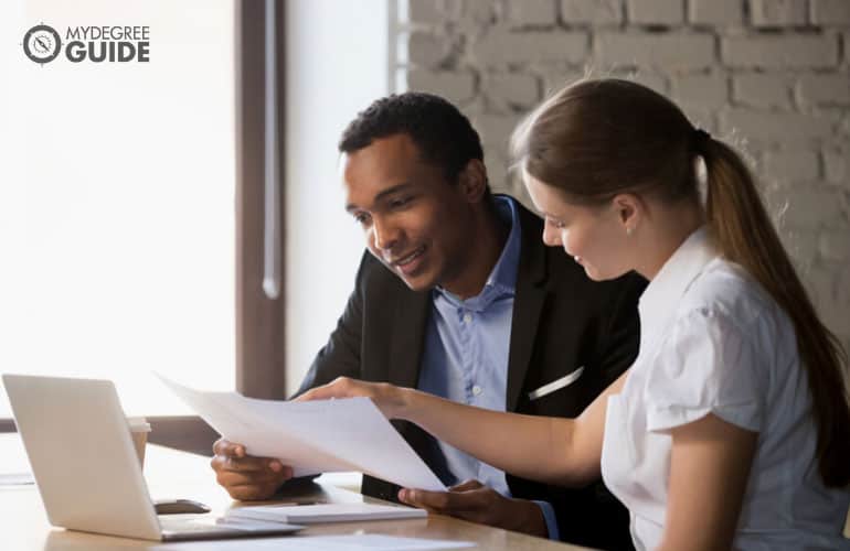 financial analyst talking to a client in an office