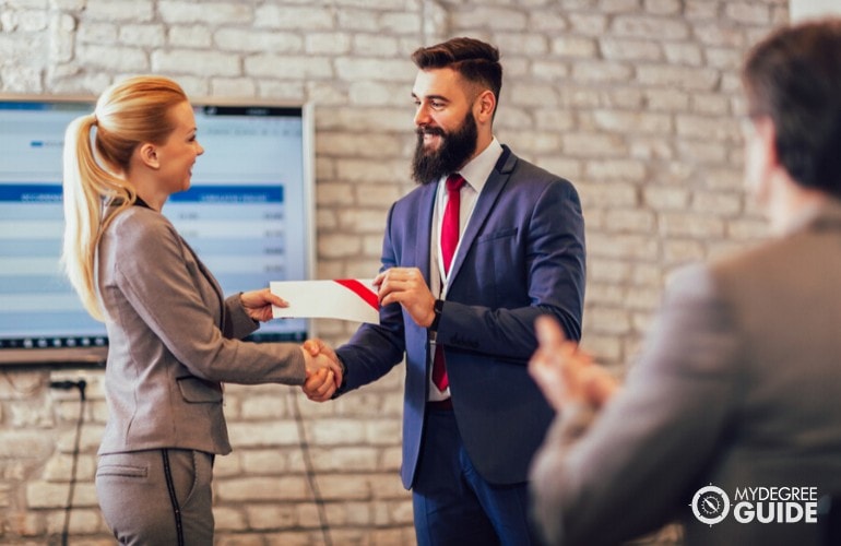 marketing manager receiving a certificate