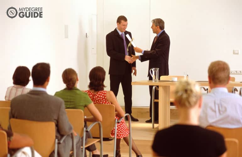 sports manager receiving a certificate