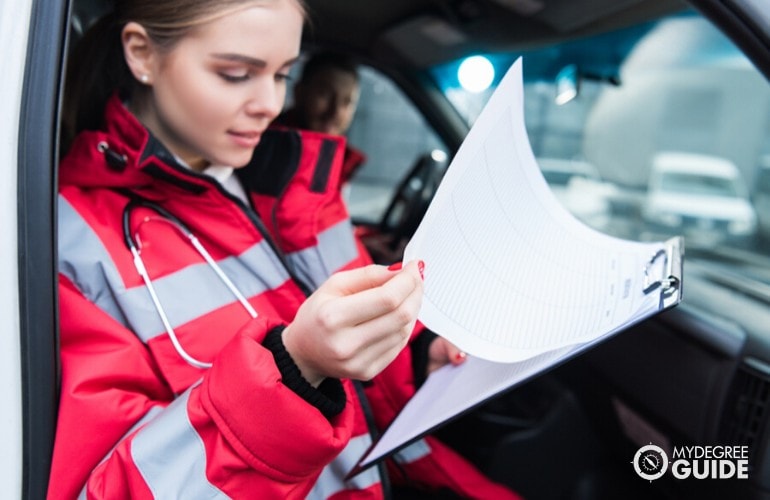 emergency medical technologist looking at a clipboard