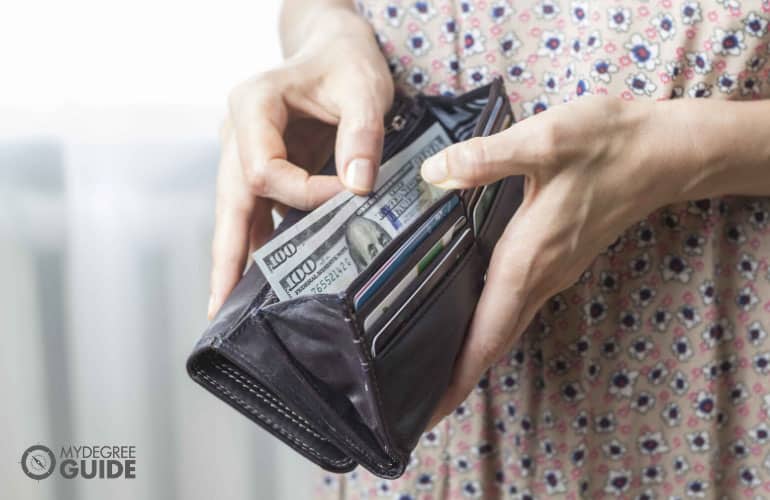 someone counting money out of her wallet