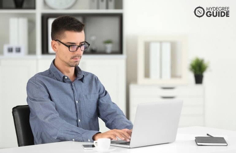 public health student studying on his laptop