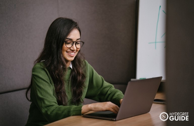 Master's in Teaching Degree students studying on her laptop