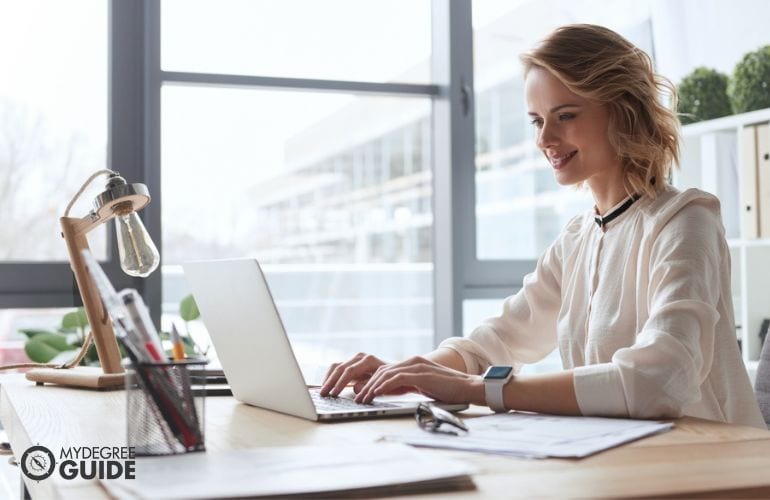 Master's in Organizational Leadership Degree student studying on her laptop