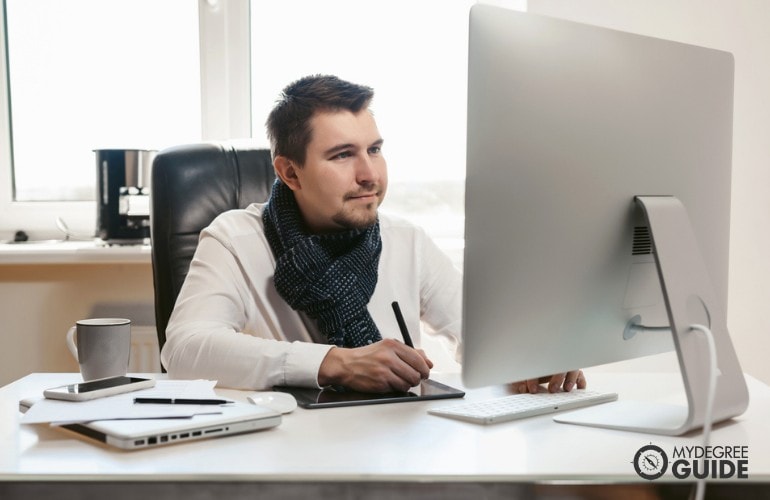 PhD in Cyber Security student studying in his office