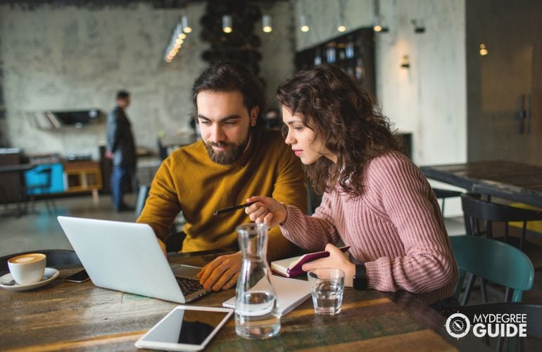 Couple choosing Masters in Journalism program online 