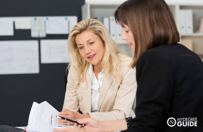 female employees discussing employee benefits