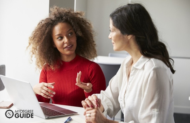 accountant explaining to intern some work related stuff