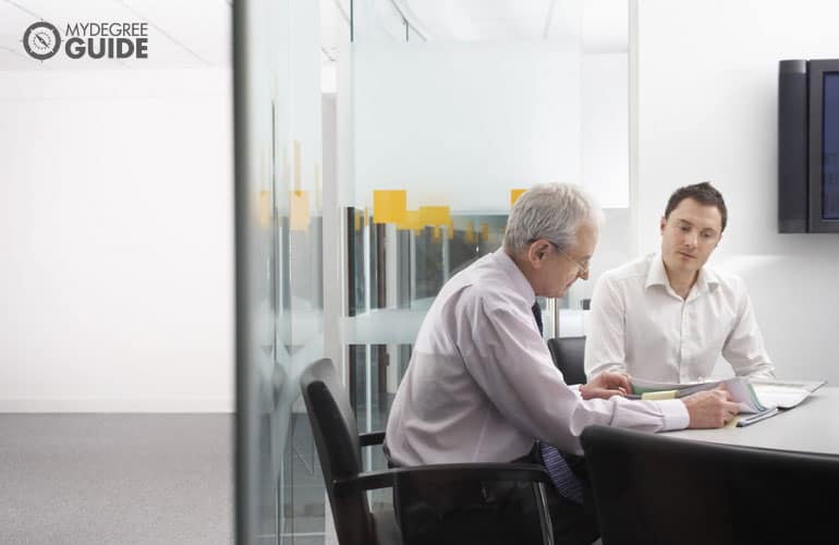 meeting between two people comparing documents