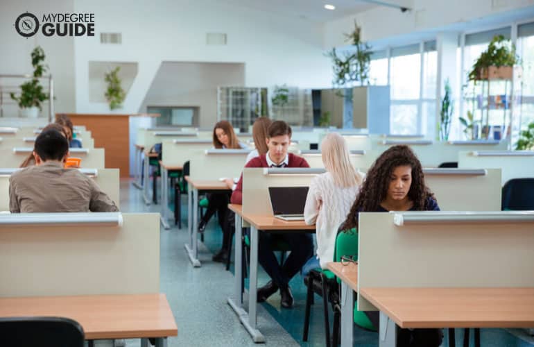 high school students studying in college library