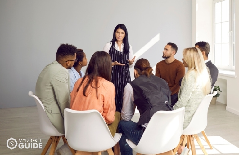 Industrial-Organizational Psychologist discussing with some employees