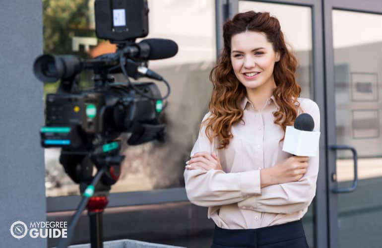 female journalist getting ready on camera