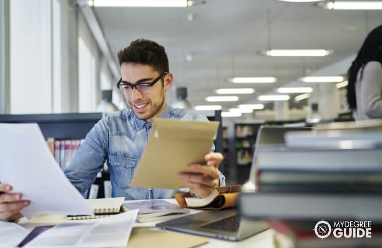young journalist checking documents