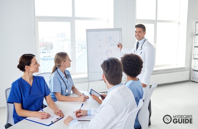 health educator explaining during a meeting with fellow health professionals