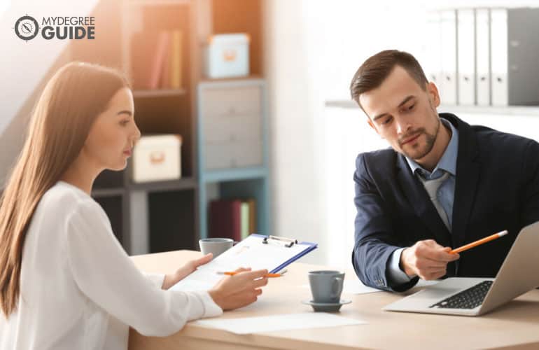 Benefits managers of a company discussing in an office during a meeting