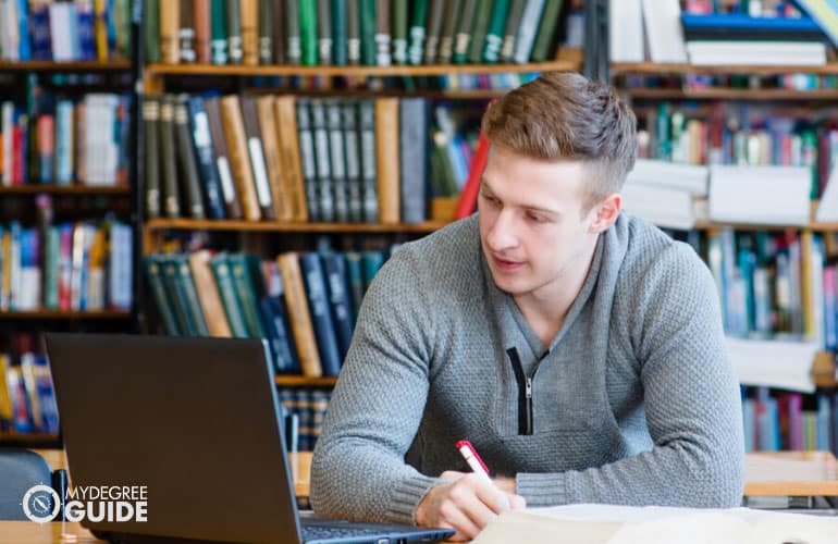 male student working on his computer