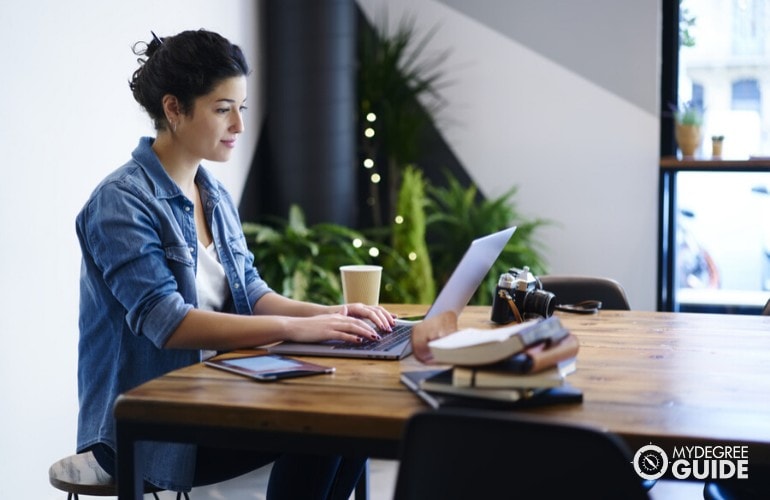 Masters in Information Technology Degree student studying at a cafe