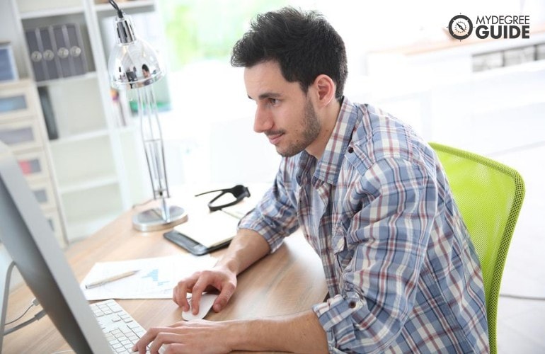 web designer working on his computer at home