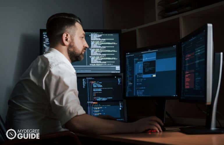 Computer programmer sitting at desk