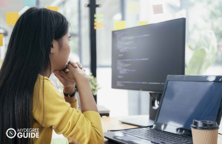 female programmer looking at her computer