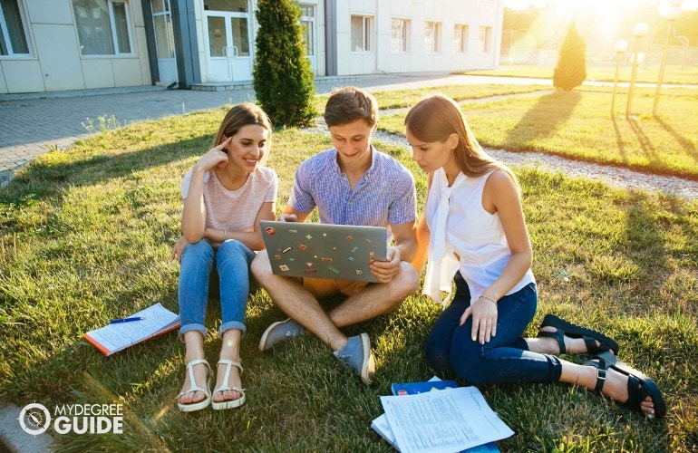 a group of friends looking at a computer screen