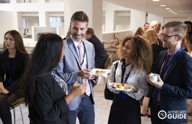 computer science professionals talking to each other during seminar