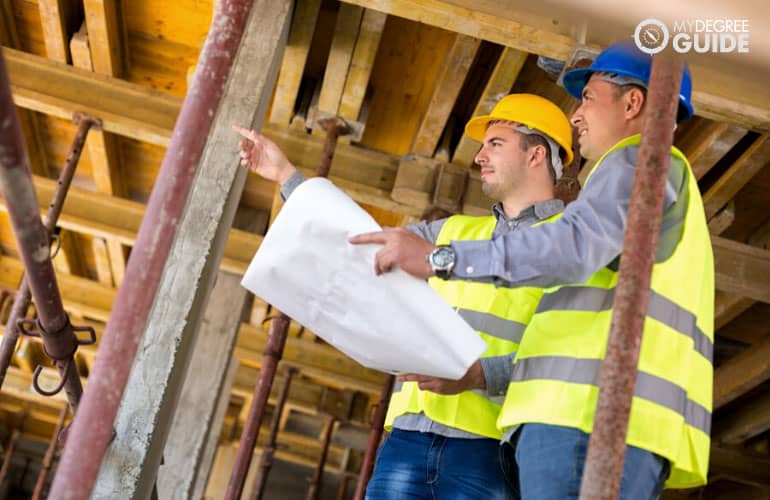 construction supervisor talking to colleague