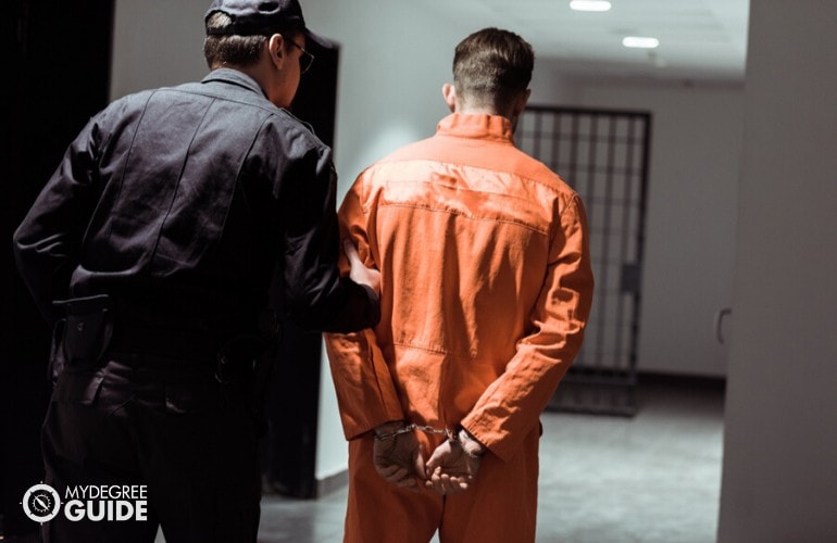 corrections officer assisting an inmate 