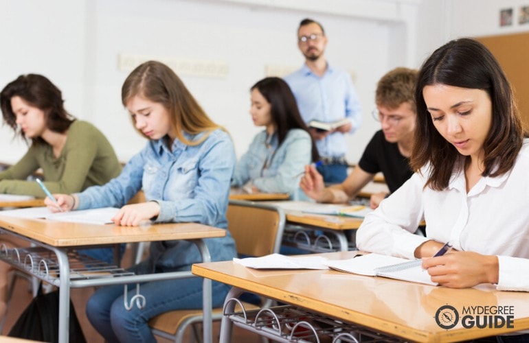 masters degree students taking notes in the classroom