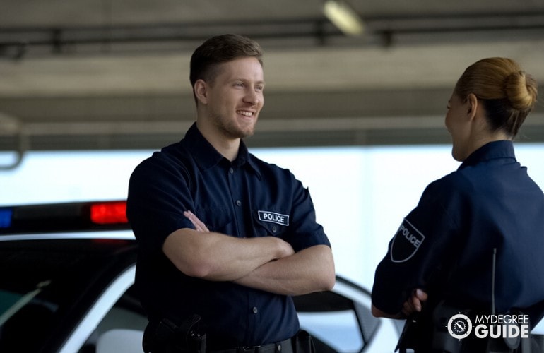 police officers talking to each other in a parking lot