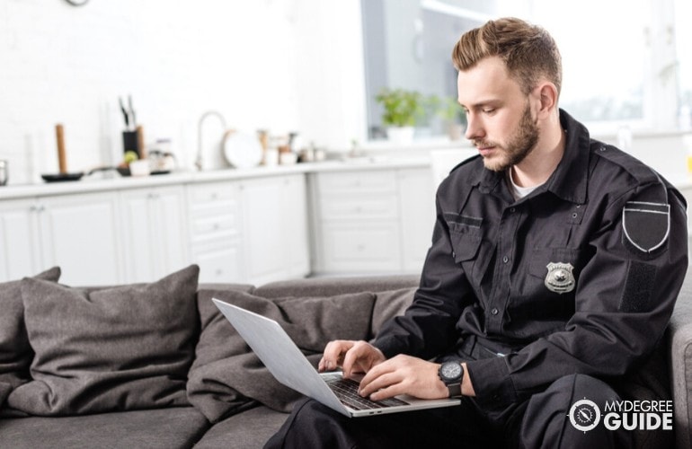 police officer studying on his laptop