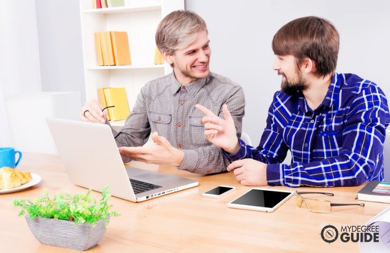 Information Security Analysts working together in the office