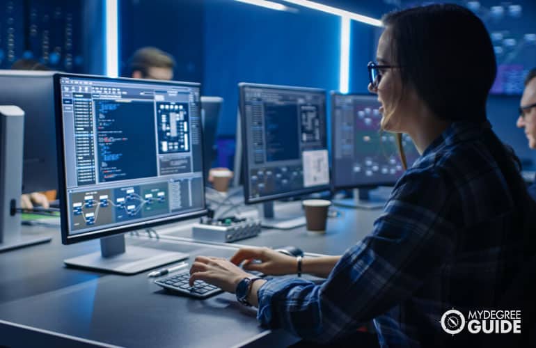 information security analyst working on her computer