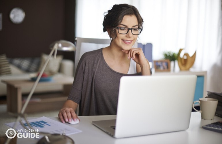 data analyst sitting in home office with laptop