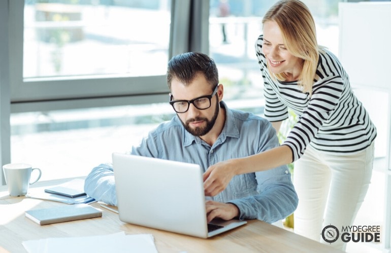 data scientist helping her colleague