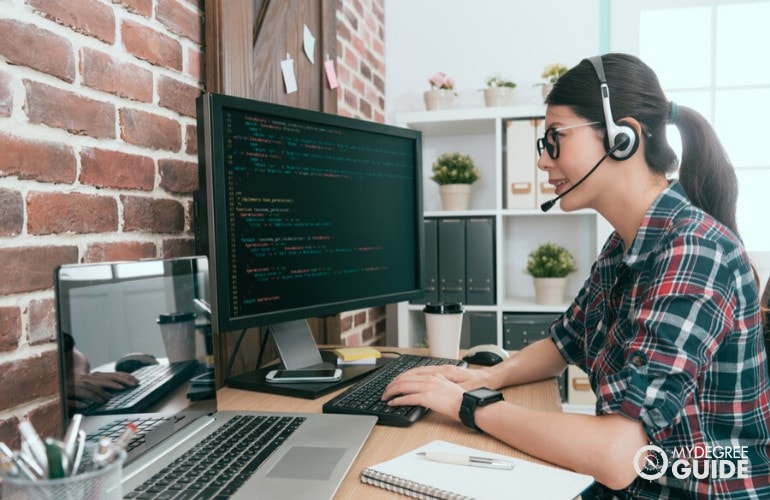 Systems Analyst working on her computer