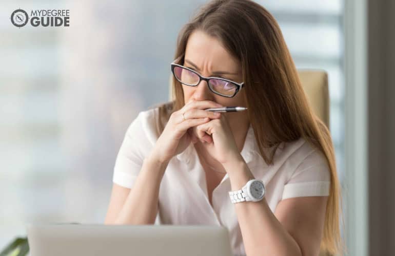 a female professional looking confused, trying to make a decision