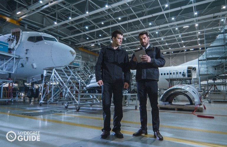 Aerospace Engineers working on an aircraft