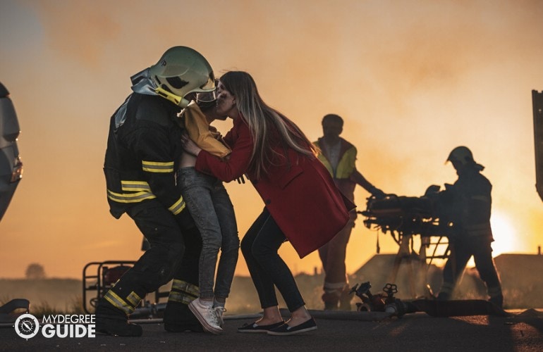 firefighter saving a child from a fire