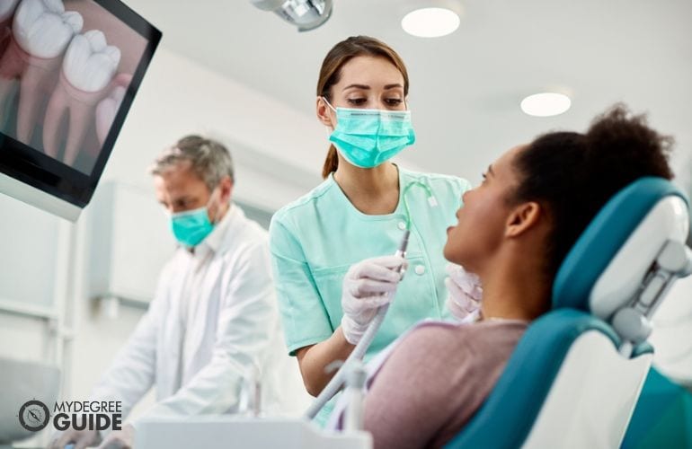 Dental Assistant preparing a patient for tooth extraction