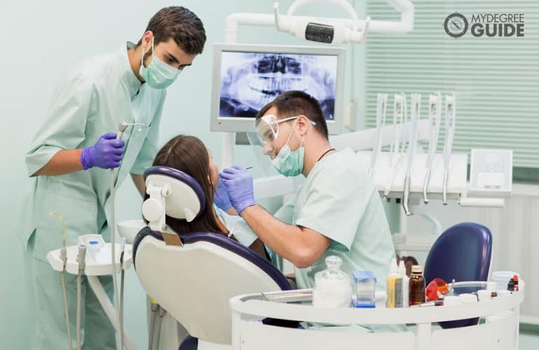 dentist with his assistant working in a clinic