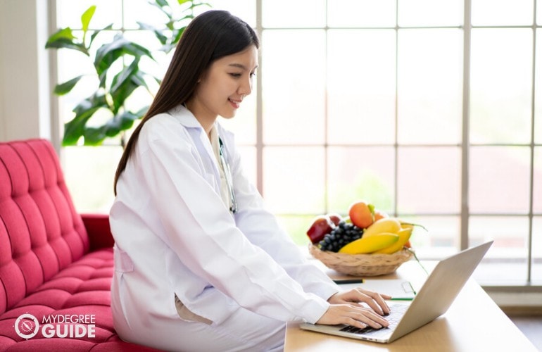 Dietitian studying on her laptop