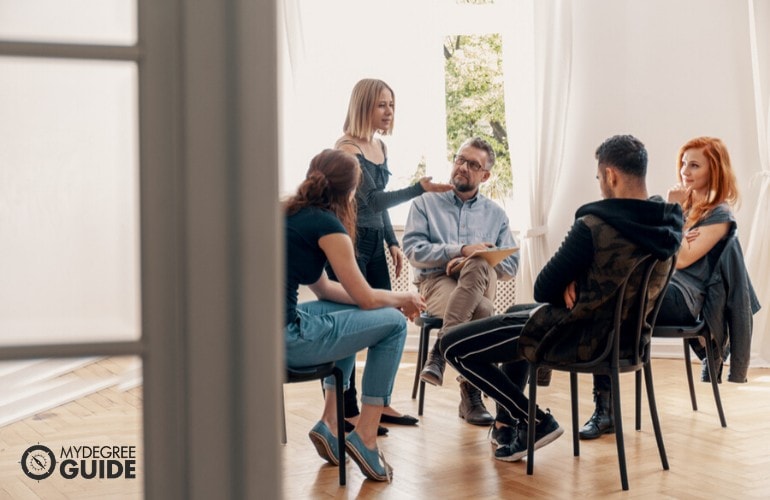 counselor talking to his patients during group counseling