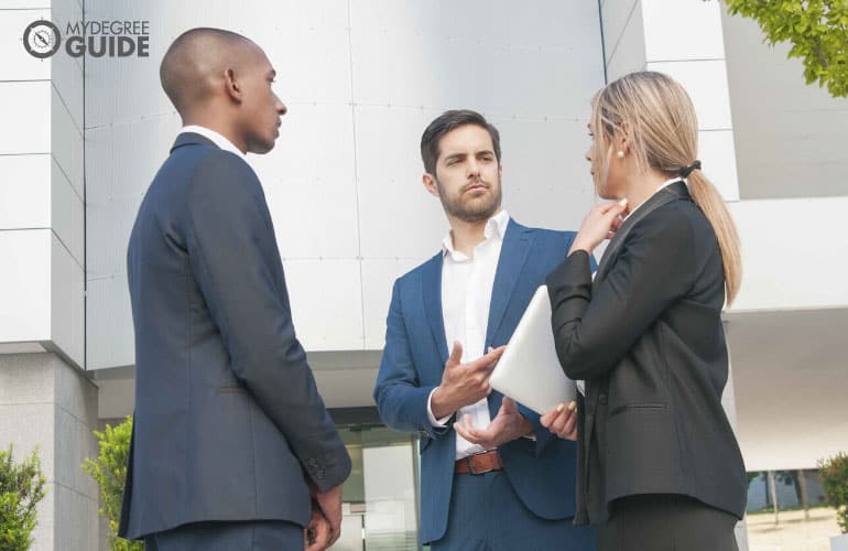 professionals talking outside a building