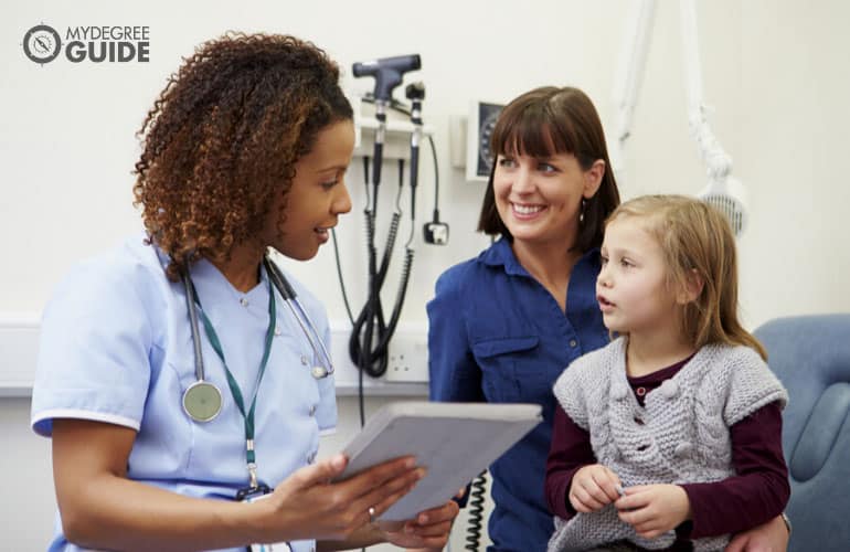 nurse checking on a young patient