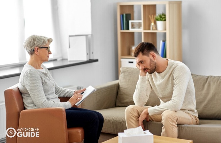 psychologist comforting her patient during therapy session