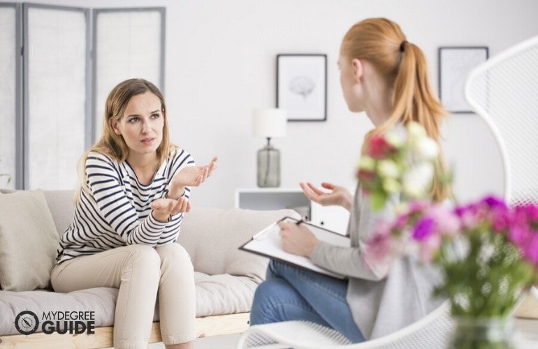 counselor talking to her patient in an office